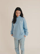 poochie-pie-front-text-hoodie-hood-oversized-blue-white-dog-mum-mumma-mom-dogs-relaxed-360gsm-cotton-girl-female-women-standing